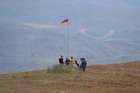 Men install an Armenian flag next to a checkpoint on the road leading to Artsakh near the border village of Kornidzor, Armenia, Sept. 22, 2023.