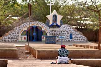A displaced Christian woman prays in front of a grotto with a statue of Mary in Kaya, Burkina Faso, May 16, 2019. Hundreds of thousands of people have been forced out of their homes in Burkina Faso as Christian communities are targeted in a spiral of Islamist killings.
