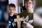 Lupcho Bojkovski (left) and Declan Shiels pose with their handmade Crosses. Students in Grade 6 at St. Bridget Catholic School built each Cross by hand using clothespins. 